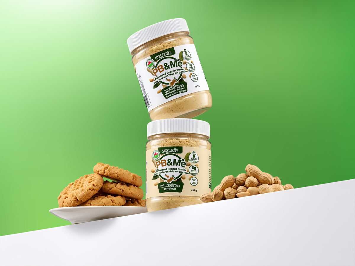 Two 453 g jars of PB&Me organic powdered peanut butter — No Sugar Added and Original — with peanut butter cookies and peanuts in the shell