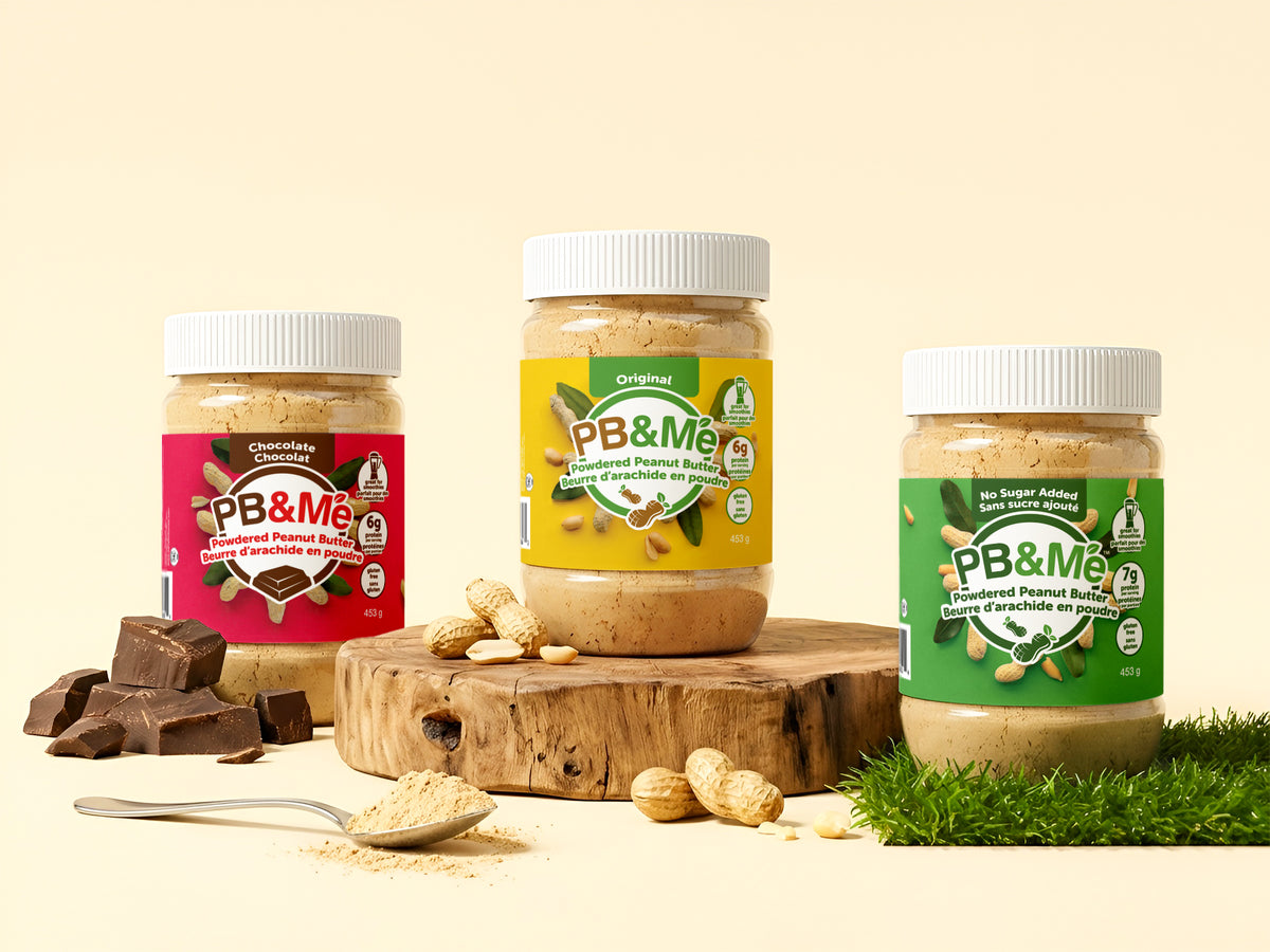 Three 453 g jars of PB&Me powdered peanut butter — Chocolate, Original and No Sugar Added — with peanuts and a spoonful of the powder